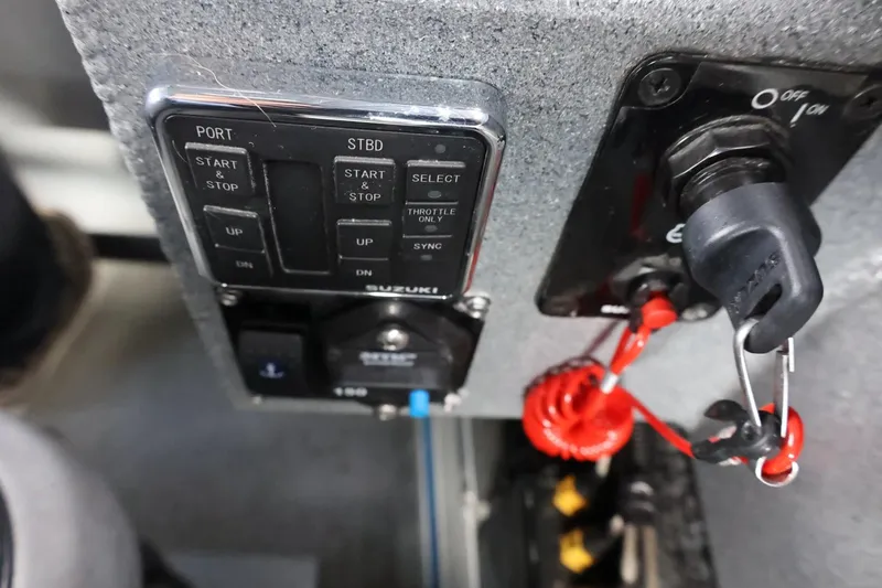 Slide: The Image of Control panel of a 2015 Duckworth 26 Offshore boat with ignition key and switches. - 44
