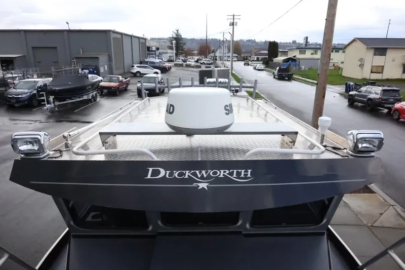 Slide: The Image of 2015 Duckworth 26 Offshore boat parked in an industrial area, showcasing its robust design. - 49