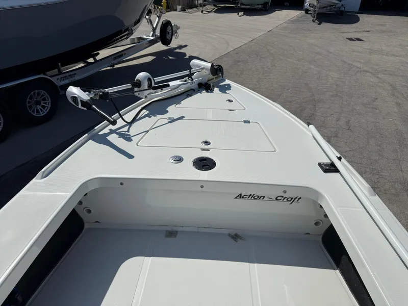 Slide: The Image of 2003 Action Craft 1820 boat deck with trolling motor, parked on a trailer. - 10