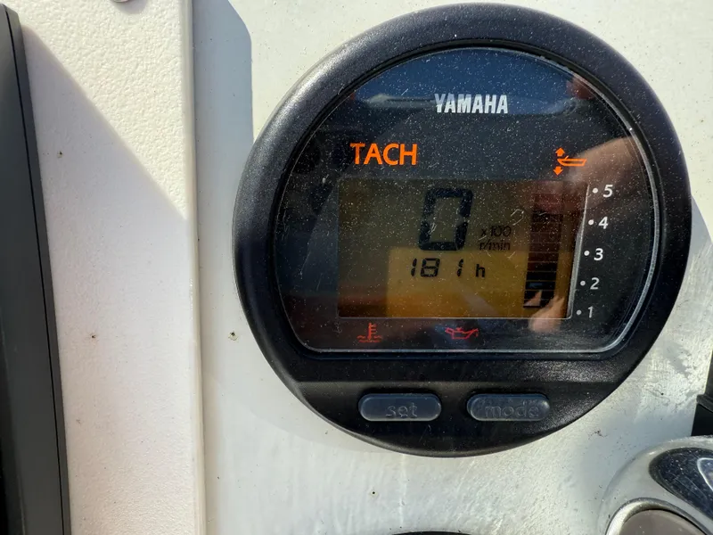 Slide: The Image of Yamaha tachometer displaying 181 hours on a 2003 Action Craft 1820 boat. - 11