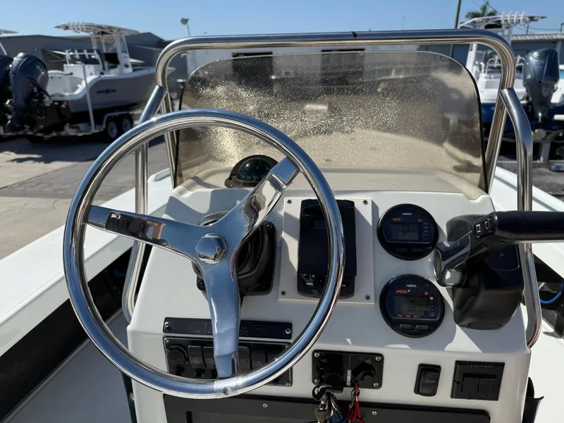 Slide: The Image of 2003 Action Craft 1820 boat dashboard with steering wheel and gauges. - 12