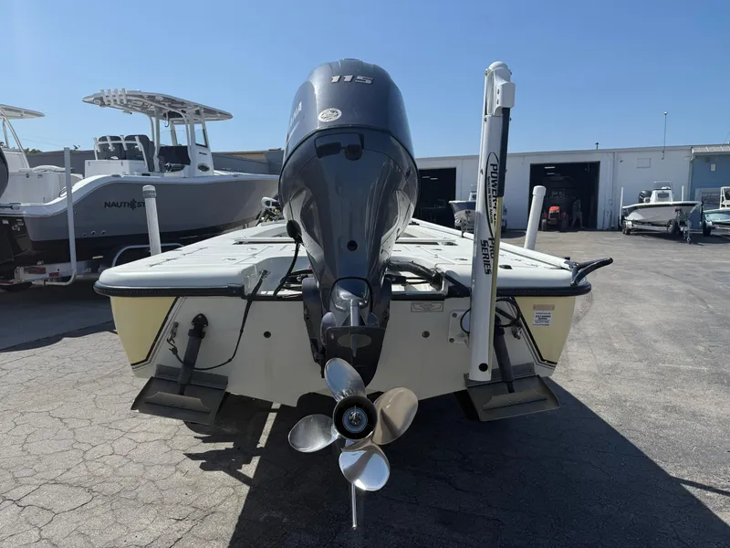 Slide: The Image of 2003 Action Craft 1820 boat with outboard motor, parked in a marina. - 13