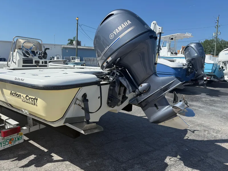 Slide: The Image of 2003 Action Craft 1820 boat with Yamaha outboard motor, parked outdoors. - 5