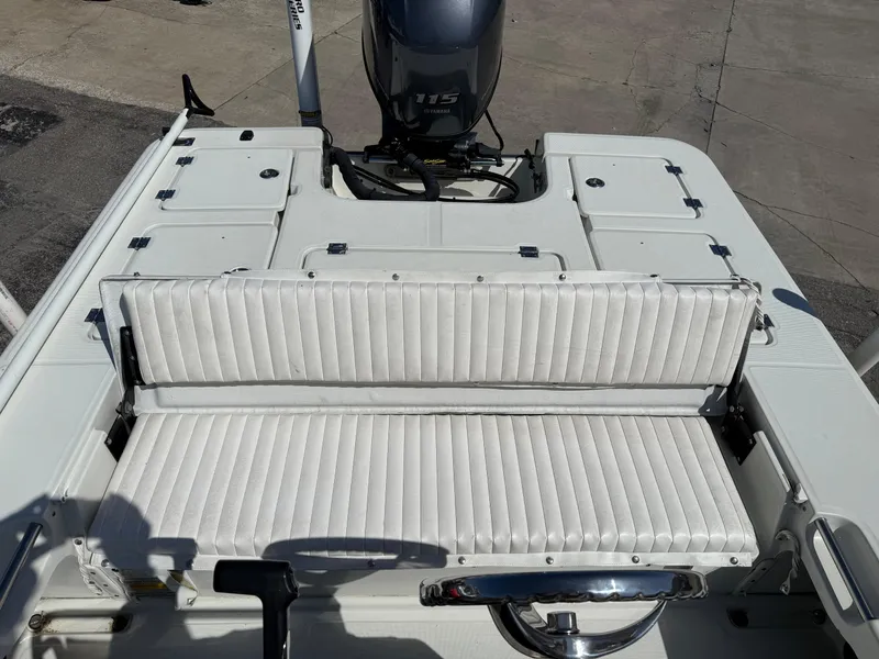 Slide: The Image of 2003 Action Craft 1820 boat interior with white seating and Yamaha 115 outboard motor. - 9