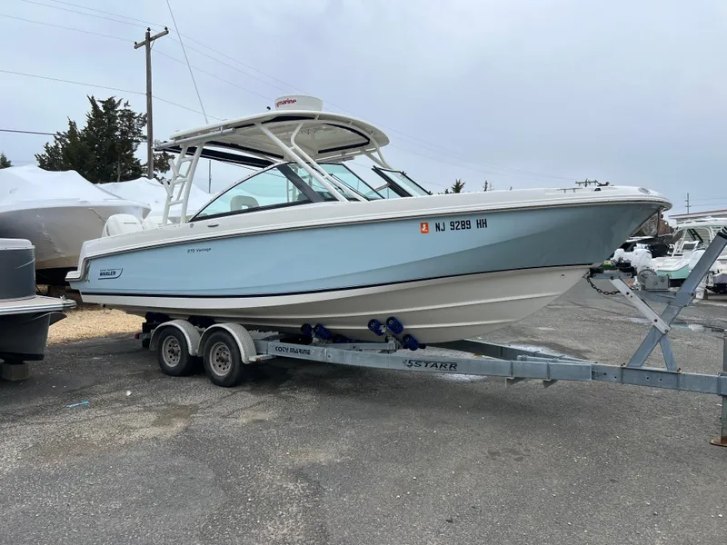Slide: The Image of 2018 Boston Whaler 270 Vantage boat on trailer in parking lot. - 1