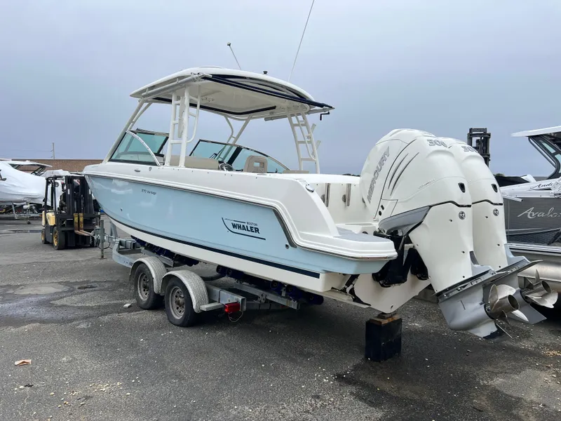 Slide: The Image of 2018 Boston Whaler 270 Vantage boat on trailer, featuring dual outboard engines. - 10