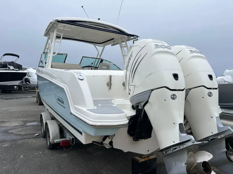 Slide: The Image of 2018 Boston Whaler 270 Vantage boat with dual engines on a trailer. - 11