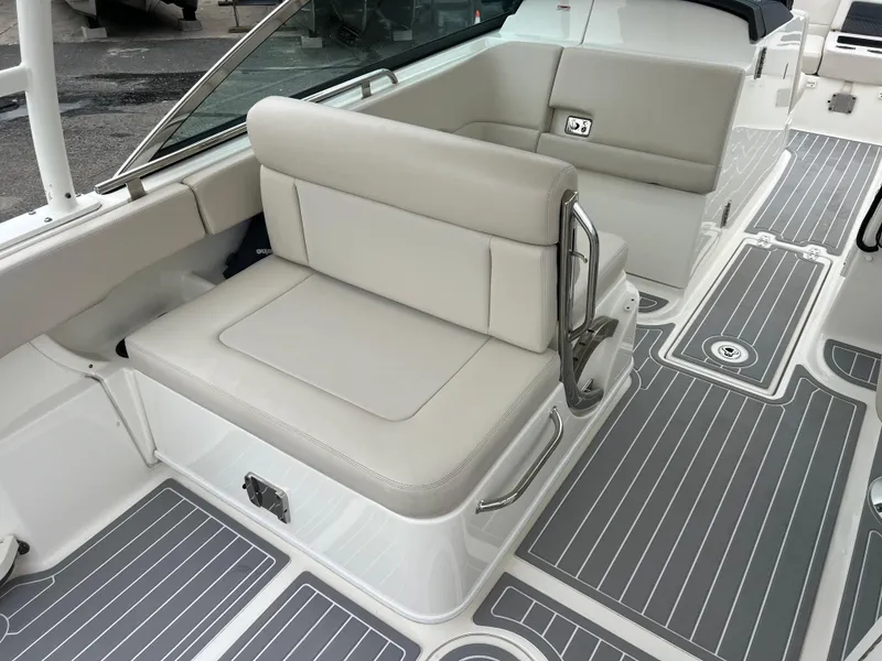 Slide: The Image of 2018 Boston Whaler 270 Vantage boat interior with cushioned seating and sleek flooring. - 17