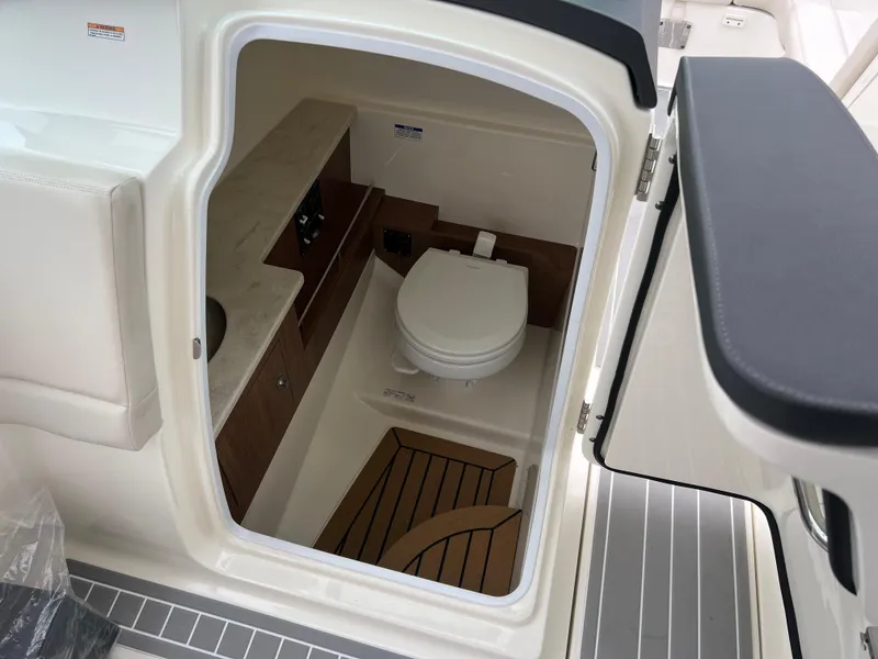 Slide: The Image of 2018 Boston Whaler 270 Vantage boat interior with compact marine toilet. - 23