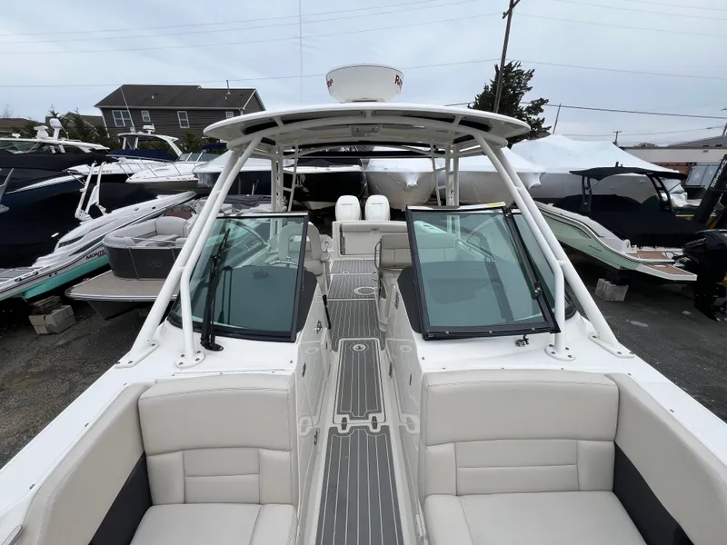 Slide: The Image of 2018 Boston Whaler 270 Vantage boat with spacious seating and sleek design in a marina. - 29