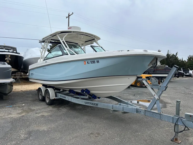 Slide: The Image of 2018 Boston Whaler 270 Vantage boat on trailer, parked outdoors. - 3