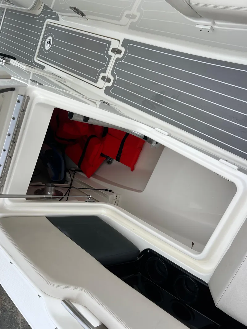Slide: The Image of 2018 Boston Whaler 270 Vantage boat interior with storage compartment and life jackets. - 33