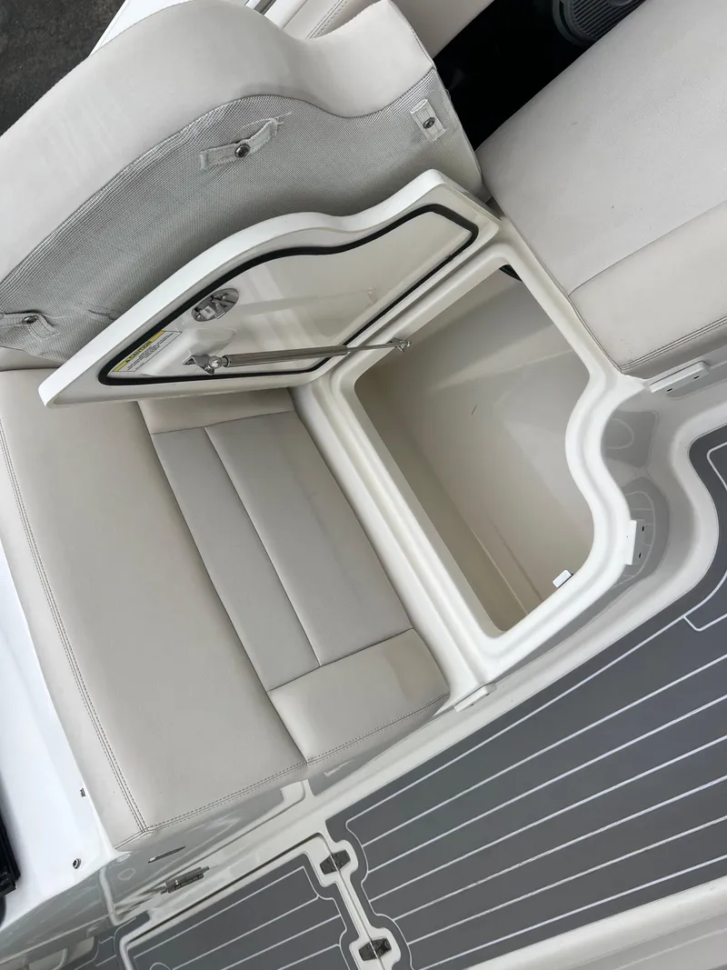 Slide: The Image of 2018 Boston Whaler 270 Vantage boat storage compartment with open lid, showcasing interior space. - 34