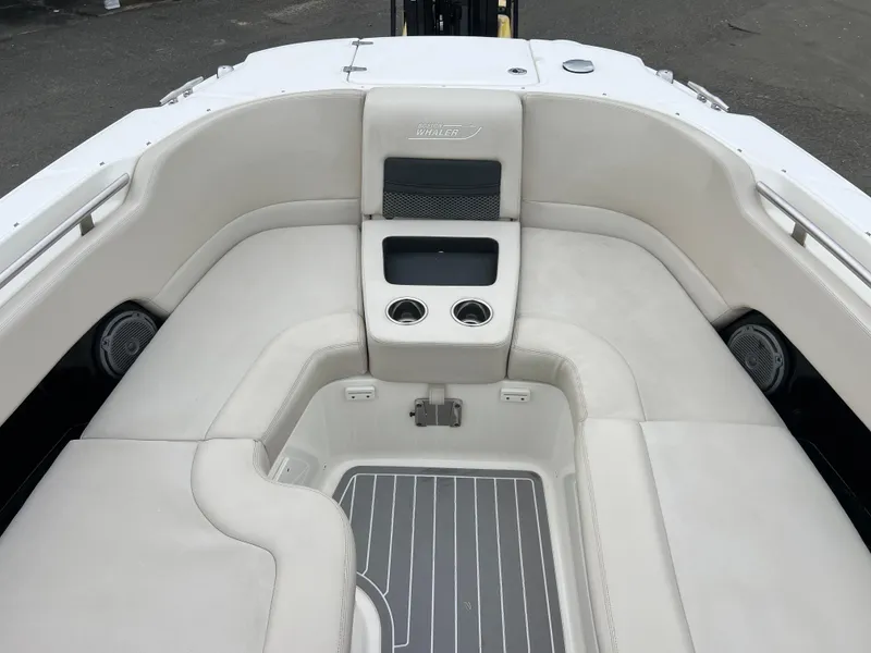 Slide: The Image of 2018 Boston Whaler 270 Vantage boat interior with cushioned seating and cup holders. - 36