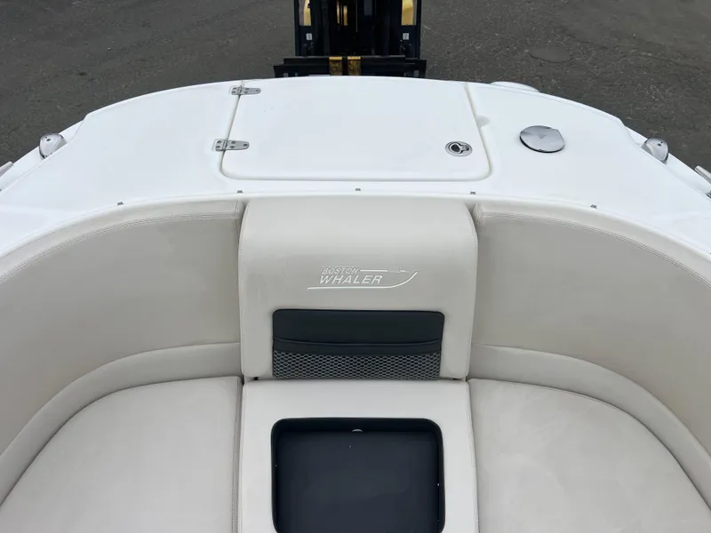Slide: The Image of 2018 Boston Whaler 270 Vantage boat interior with white seating and storage compartment. - 37