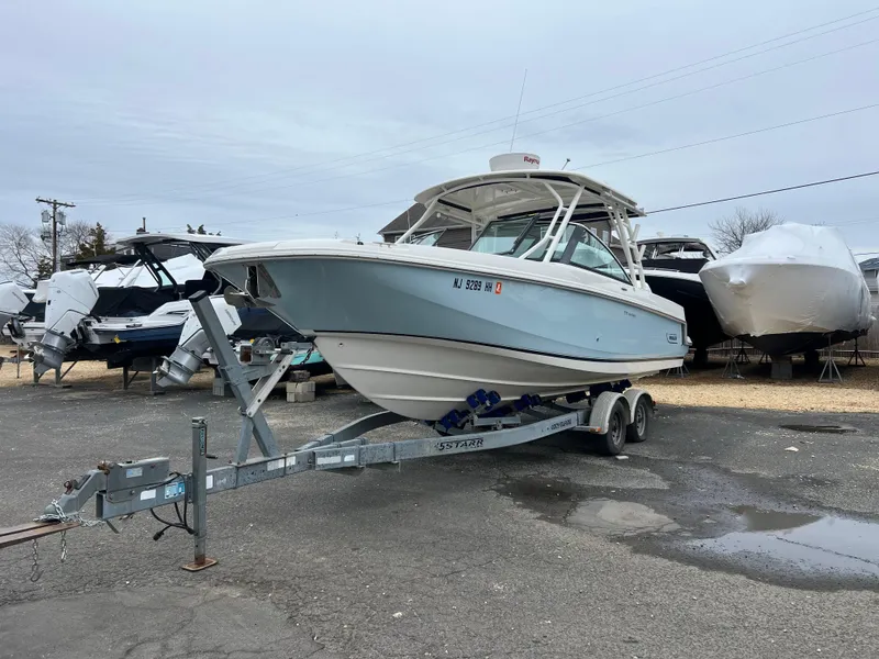 Slide: The Image of 2018 Boston Whaler 270 Vantage boat on trailer in a parking lot. - 5