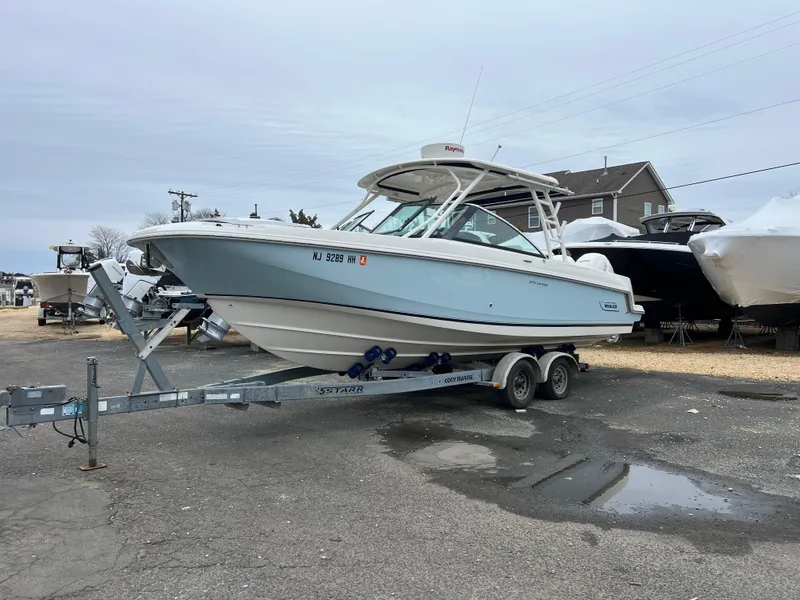 Slide: The Image of 2018 Boston Whaler 270 Vantage boat on trailer in a marina setting. - 6
