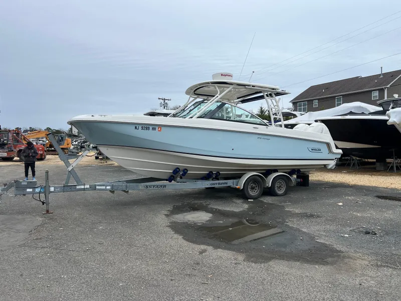 Slide: The Image of 2018 Boston Whaler 270 Vantage boat on trailer in a parking lot. - 7