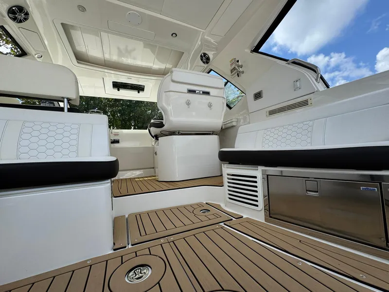Slide: The Image of 2019 Sea Ray Sundancer 350 Coupe interior with sleek seating and modern design elements. - 4