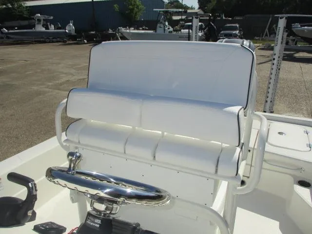Slide: The Image of 2025 Skeeter SX241 boat interior with white seating and steering wheel. - 8
