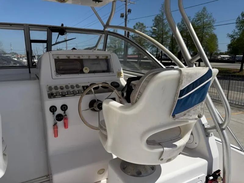 Slide: The Image of Helm of 2000 Pro-Line 27 Walk boat with steering wheel and control panel. - 10