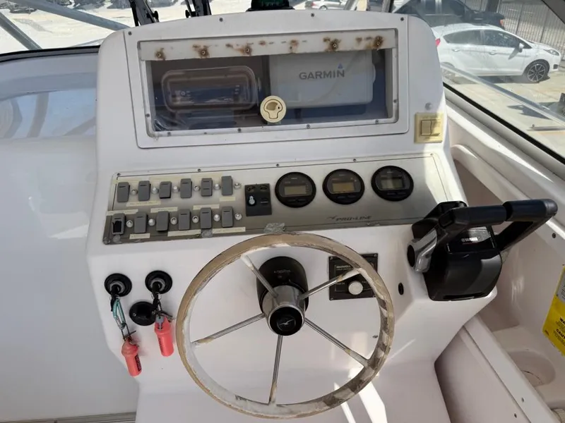 Slide: The Image of Control panel of a 2000 Pro-Line 27 Walk boat with Garmin navigation system. - 11