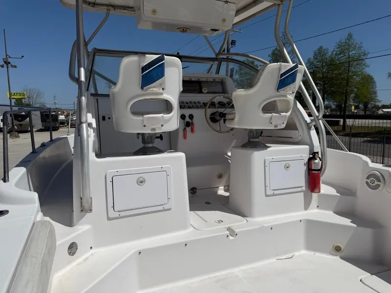 Slide: The Image of 2000 Pro-Line 27 Walk boat interior with dual seats and control panel. - 13