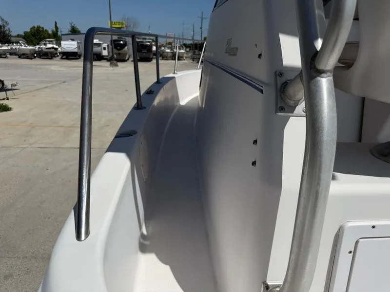 Slide: The Image of 2000 Pro-Line 27 Walk boat side view with railing in a marina setting. - 15