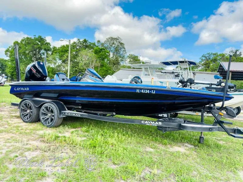 Slide: The Image of 2023 Caymas CX 20 PRO boat on trailer, parked outdoors under a blue sky. - 0