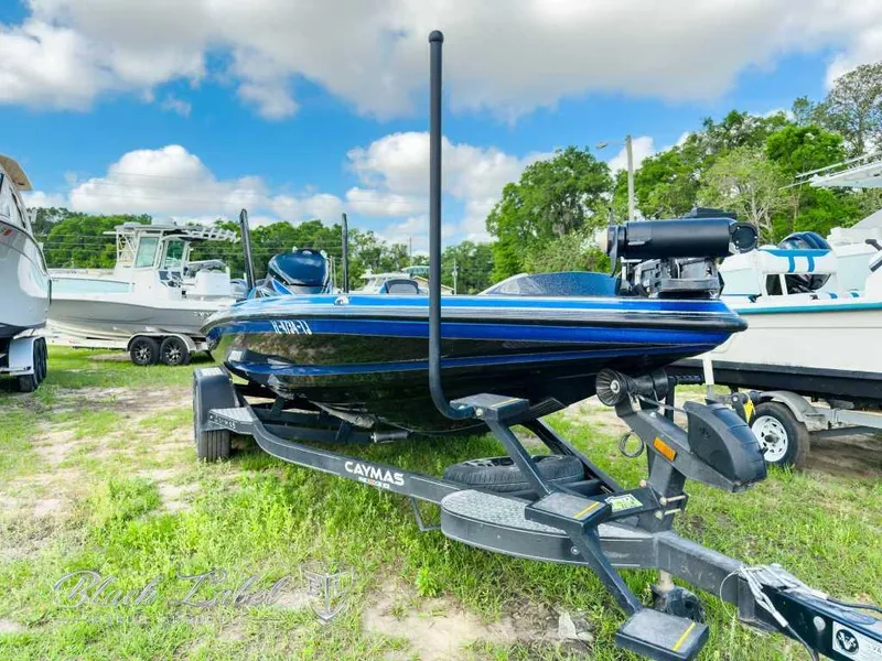 Slide: The Image of 2023 Caymas CX 20 PRO boat on trailer, parked outdoors under a blue sky. - 1