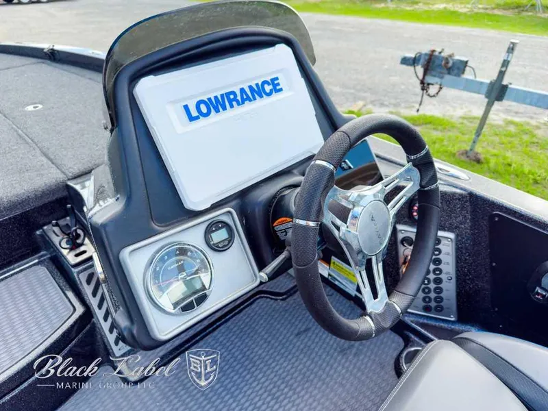 Slide: The Image of 2023 Caymas CX 20 PRO boat dashboard with Lowrance display and steering wheel. - 15