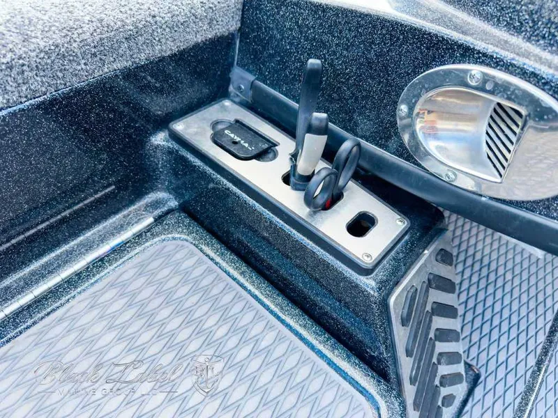 Slide: The Image of 2023 Caymas CX 20 PRO boat control panel with sleek design and textured flooring. - 18