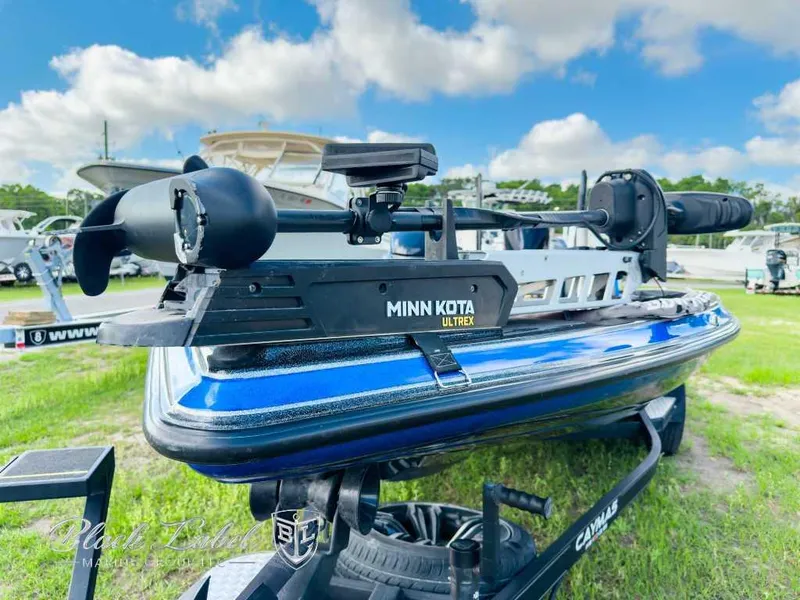 Slide: The Image of 2023 Caymas CX 20 PRO boat with Minn Kota Ultrex motor, displayed outdoors. - 2