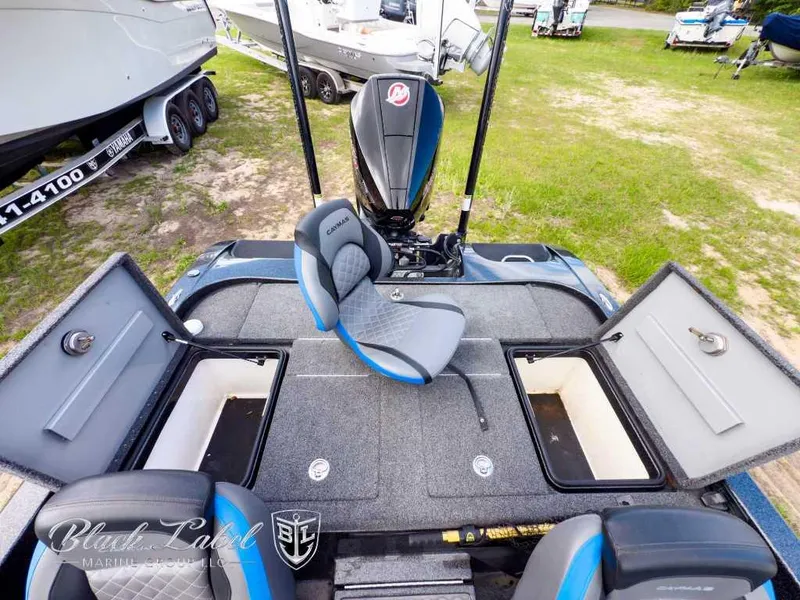 Slide: The Image of 2023 Caymas CX 20 PRO boat interior with open storage compartments and seating. - 21