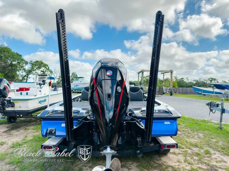 Slide: The Image of 2023 Caymas CX 20 PRO boat with powerful outboard motor, parked outdoors under a cloudy sky. - 7