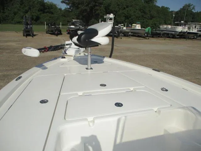 Slide: The Image of 2025 Skeeter SX241 boat deck with trolling motor, parked outdoors. - 11