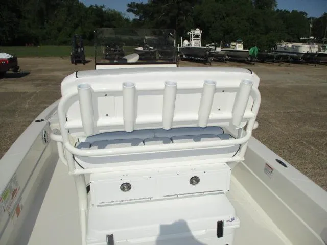 Slide: The Image of 2025 Skeeter SX241 boat with rod holders and storage, parked outdoors. - 12