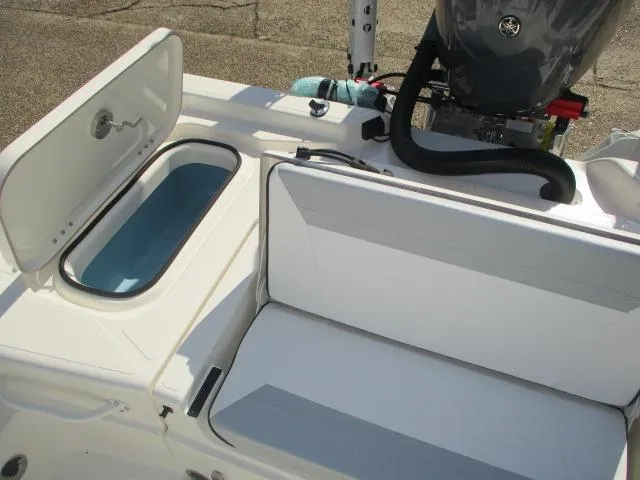 Slide: The Image of 2025 Skeeter SX241 boat interior with open storage compartments and engine view. - 13