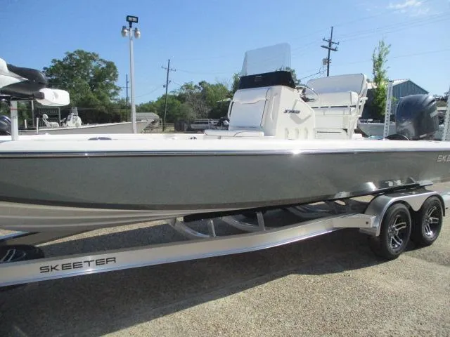 Slide: The Image of 2025 Skeeter SX241 boat on trailer, sleek design, parked outdoors. - 4