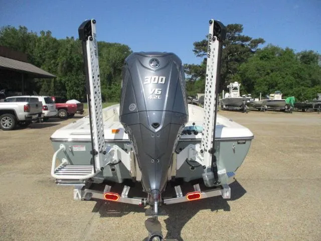 Slide: The Image of 2025 Skeeter SX241 boat with powerful 300 V6 engine, parked outdoors. - 6