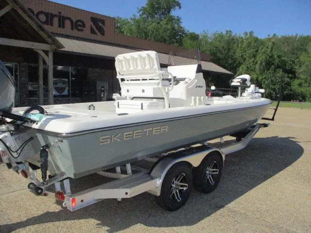 Slide: The Image of 2025 Skeeter SX241 boat on trailer outside a marine shop. - 7