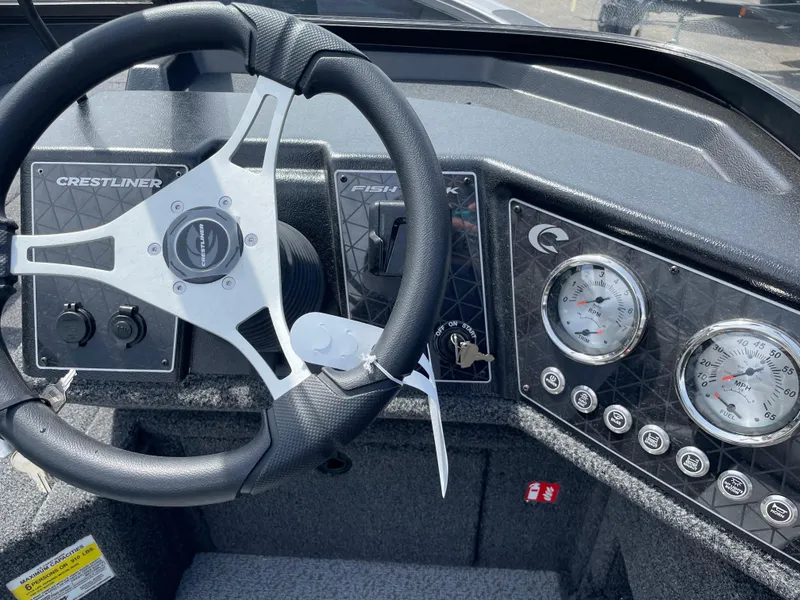 Slide: The Image of 2025 Crestliner 1750 Fish Hawk dashboard with steering wheel and gauges. - 10