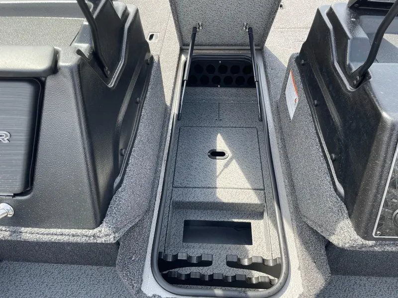 Slide: The Image of 2025 Crestliner 1750 Fish Hawk interior storage compartment with rod holders and organized layout. - 13