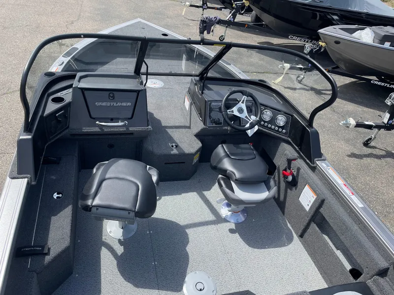 Slide: The Image of 2025 Crestliner 1750 Fish Hawk boat interior with seating and steering console. - 3