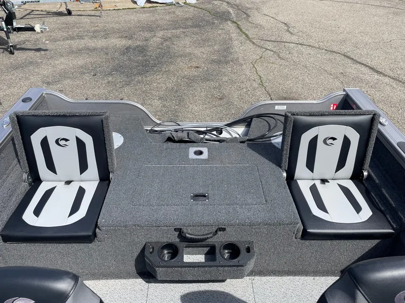 Slide: The Image of 2025 Crestliner 1750 Fish Hawk boat interior with two cushioned seats and storage compartments. - 4