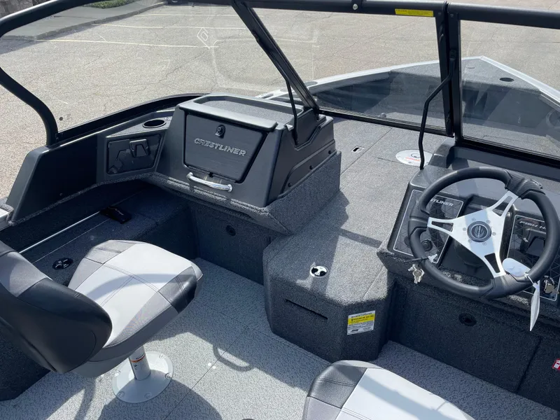 Slide: The Image of 2025 Crestliner 1750 Fish Hawk boat interior with steering wheel and seating. - 9