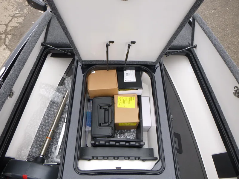 Slide: The Image of Open storage compartment of 2025 Ranger Z519R Cup-Equipped, containing various boxes and equipment. - 14