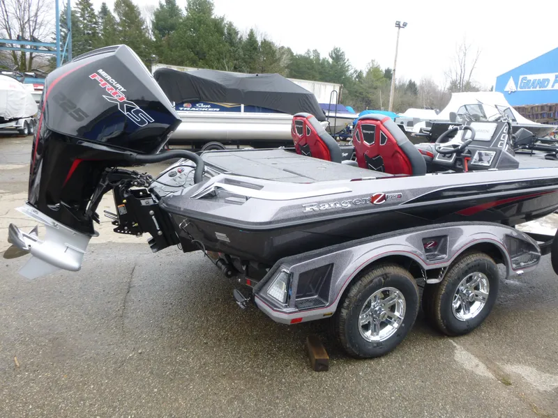 Slide: The Image of 2025 Ranger Z519R Cup-Equipped boat with powerful outboard motor, parked outdoors. - 4