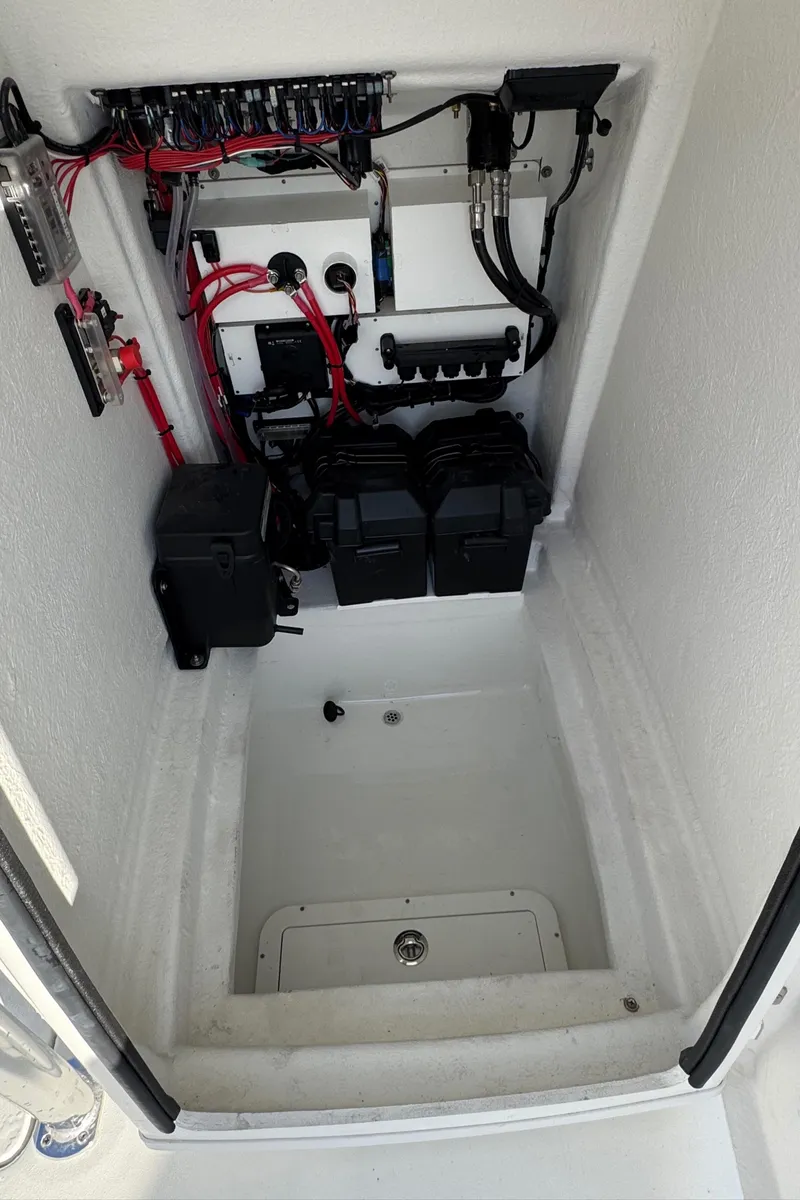 Slide: The Image of 2025 Pair Customs 24 Center Console DV electrical compartment with wiring and battery setup. - 10