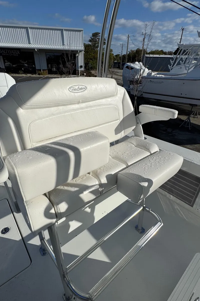 Slide: The Image of 2025 Pair Customs 24 Center Console DV boat seat, white upholstery, sunny day. - 5